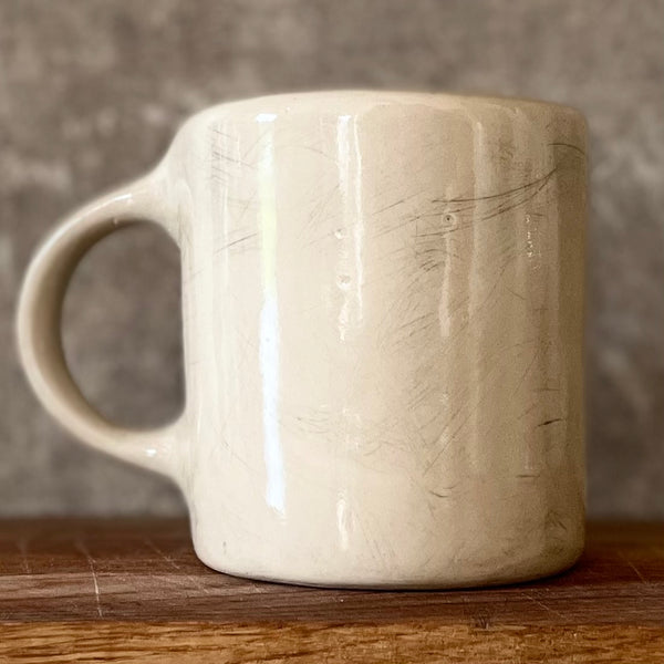 Ceramic mug with saying about balance with handle