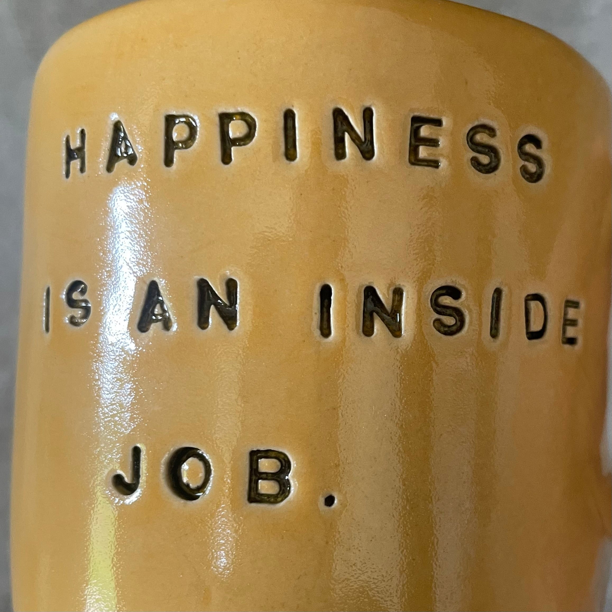 Yellow coffee mug with saying about happiness