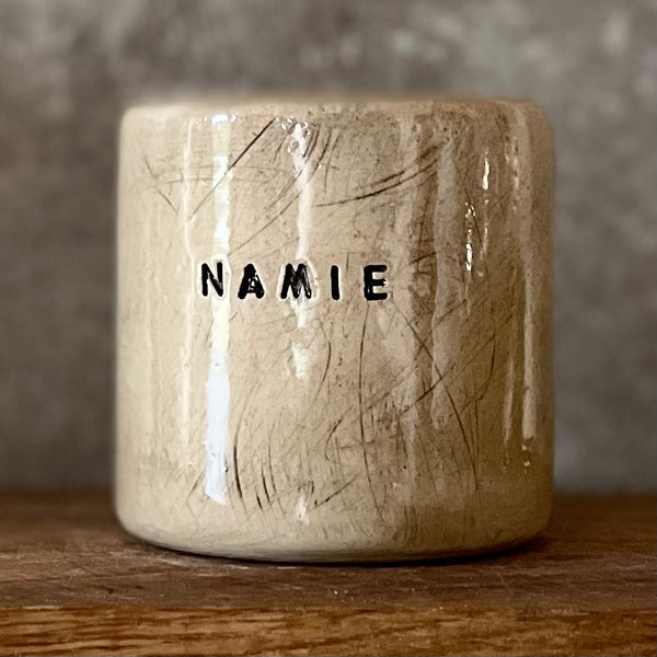 Beige mug with word in NAMIE