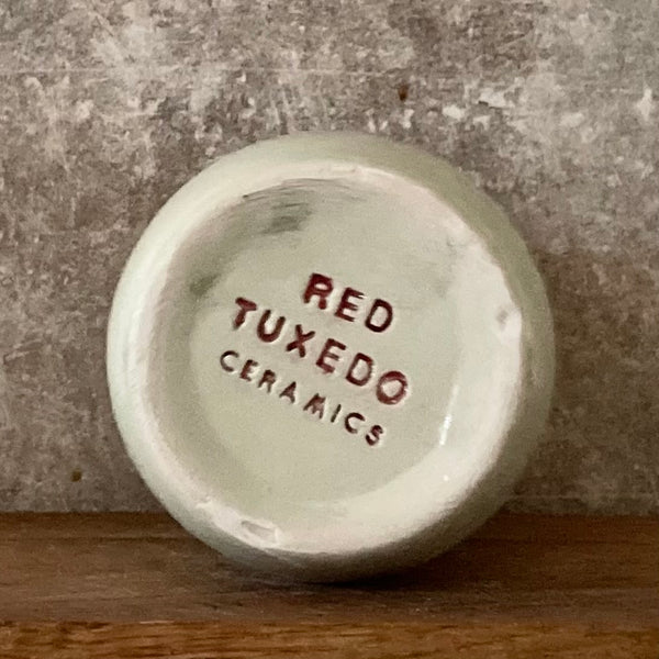 Pale blue mug with saying in Spanish