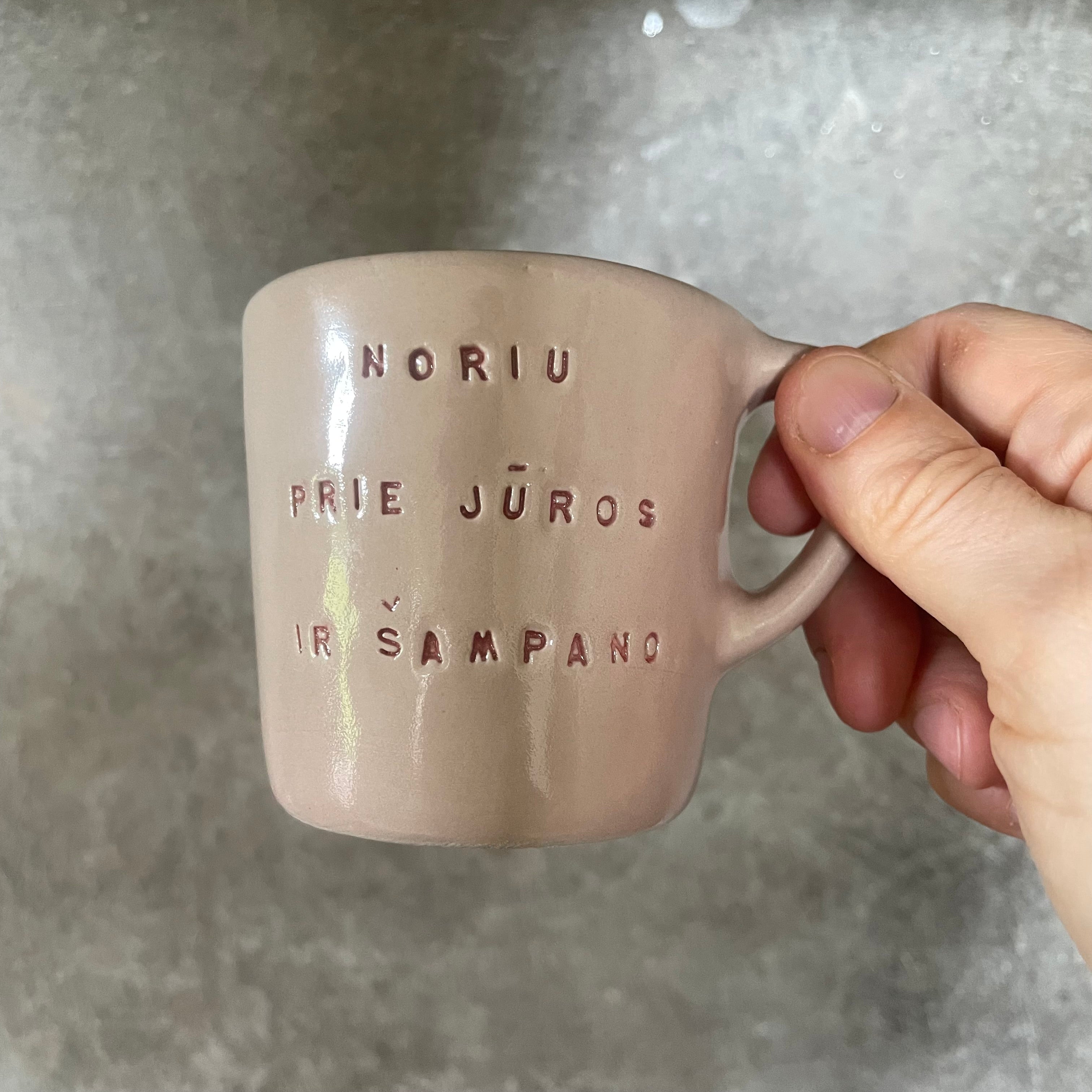 Small pink mug with words in Lithuanian