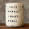White mug with magic saying