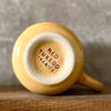 Yellow mug with optimistic text