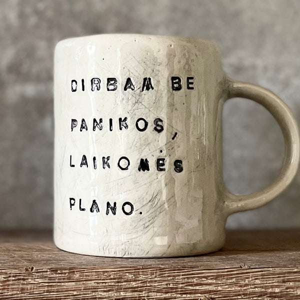 White ceramic mug with words about work