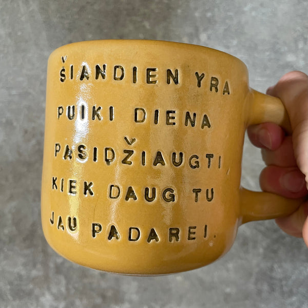Yellow mug with optimistic text