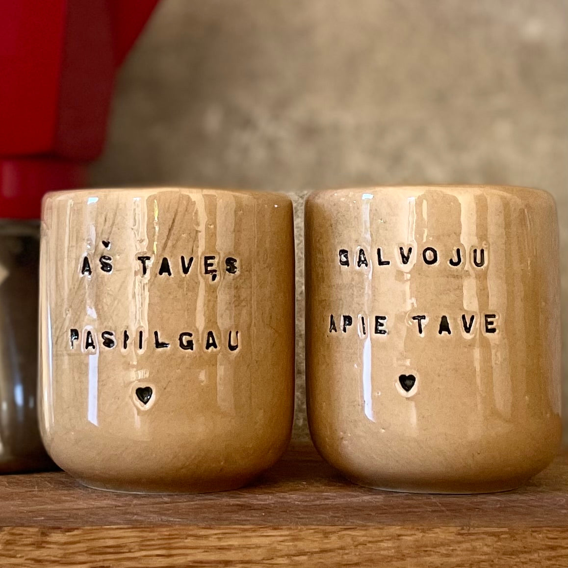 Brownish small mugs without handle with sentimental text