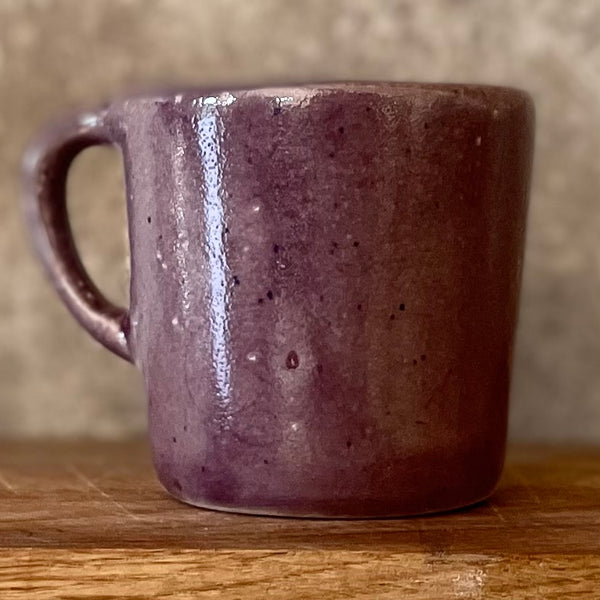 Small purple mug with words in Lithuanian