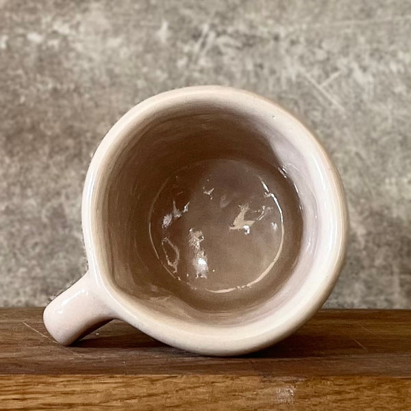 Small pink mug with words in Lithuanian