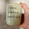Pale blue mug with saying in Spanish