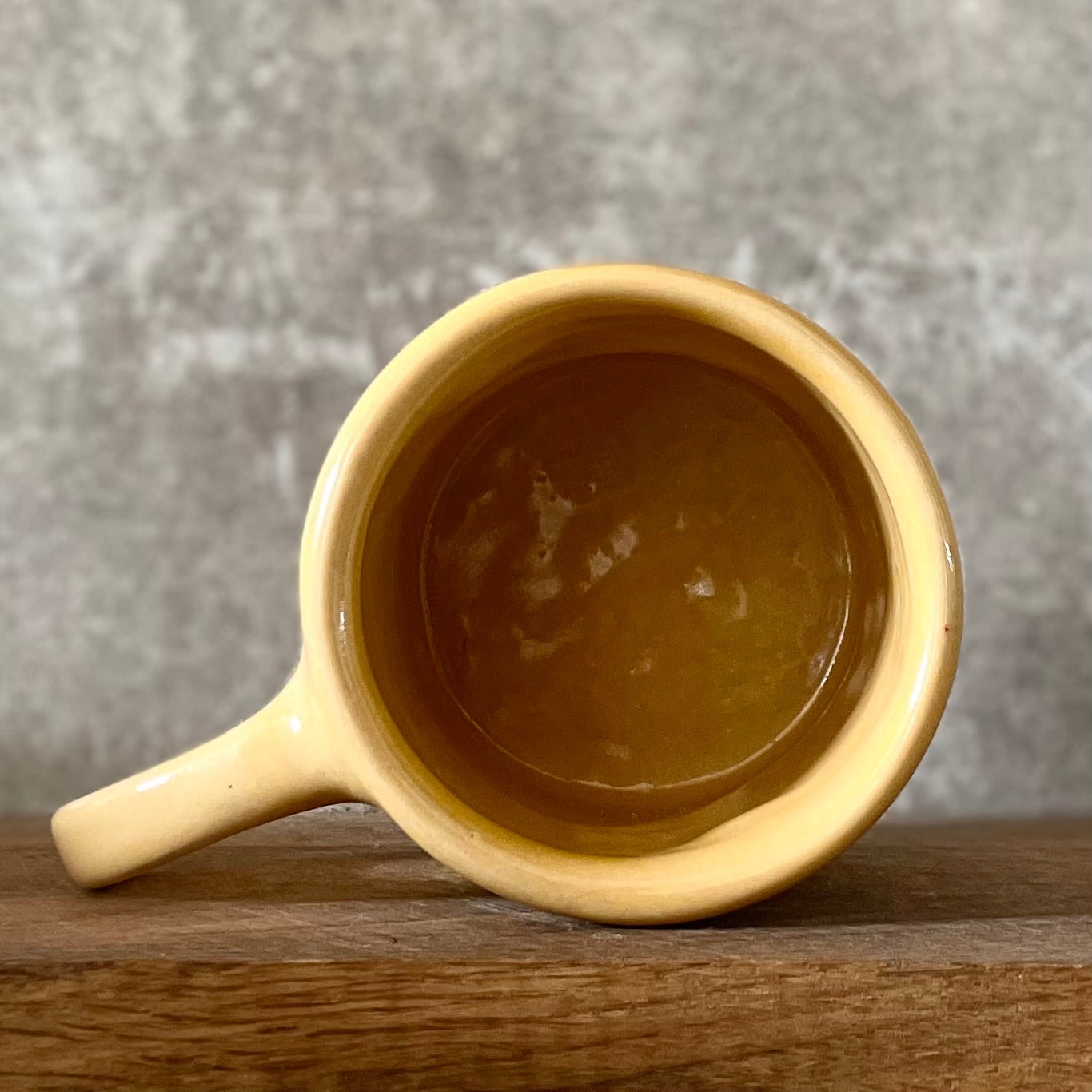 Yellow coffee mug with saying about happiness