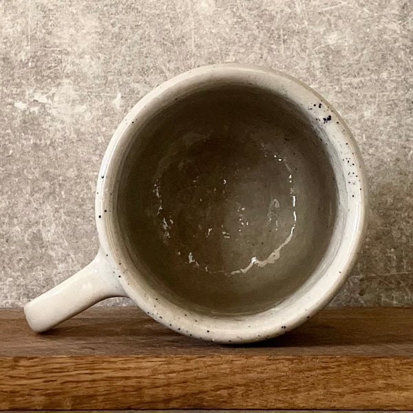 Speckled mug with cozy saying