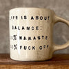 Ceramic mug with saying about balance with handle
