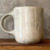 Speckled mug with words about work