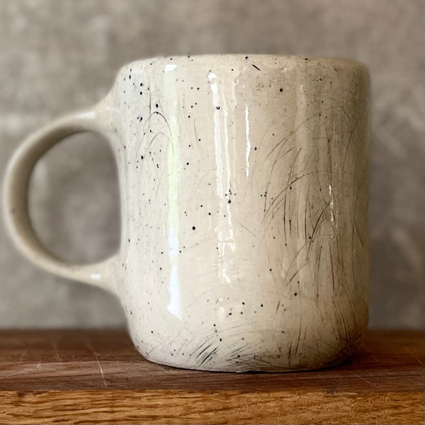 Speckled mug with words about work