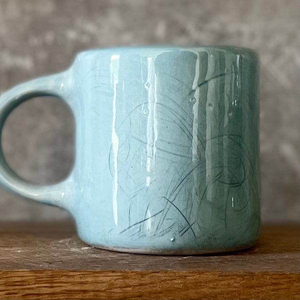 Blue ceramic mug with word PASITIKĖK