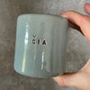 Pale blue ceramic mug "DABAR IR ČIA"