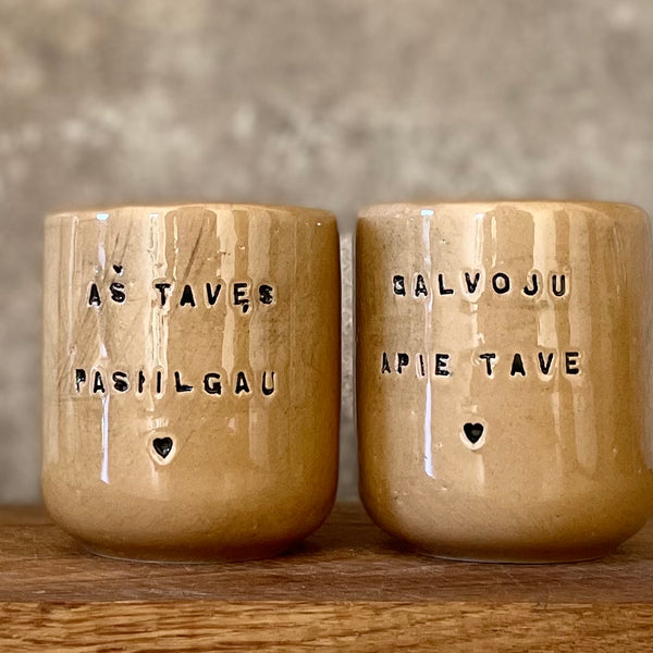 Brownish small mugs without handle with sentimental text