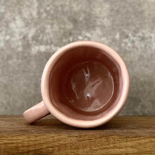 Puodelis su mielu užrašu