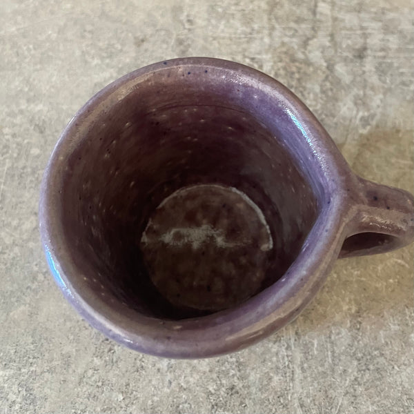 Small purple mug with words in Lithuanian