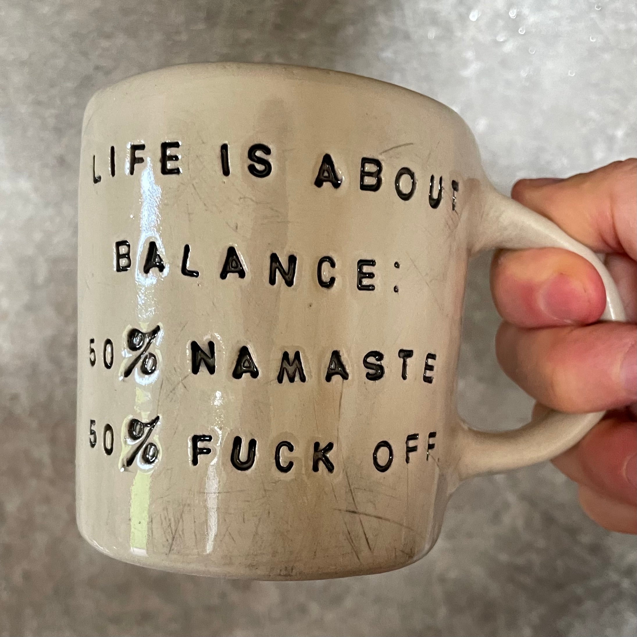 Ceramic mug with saying about balance with handle