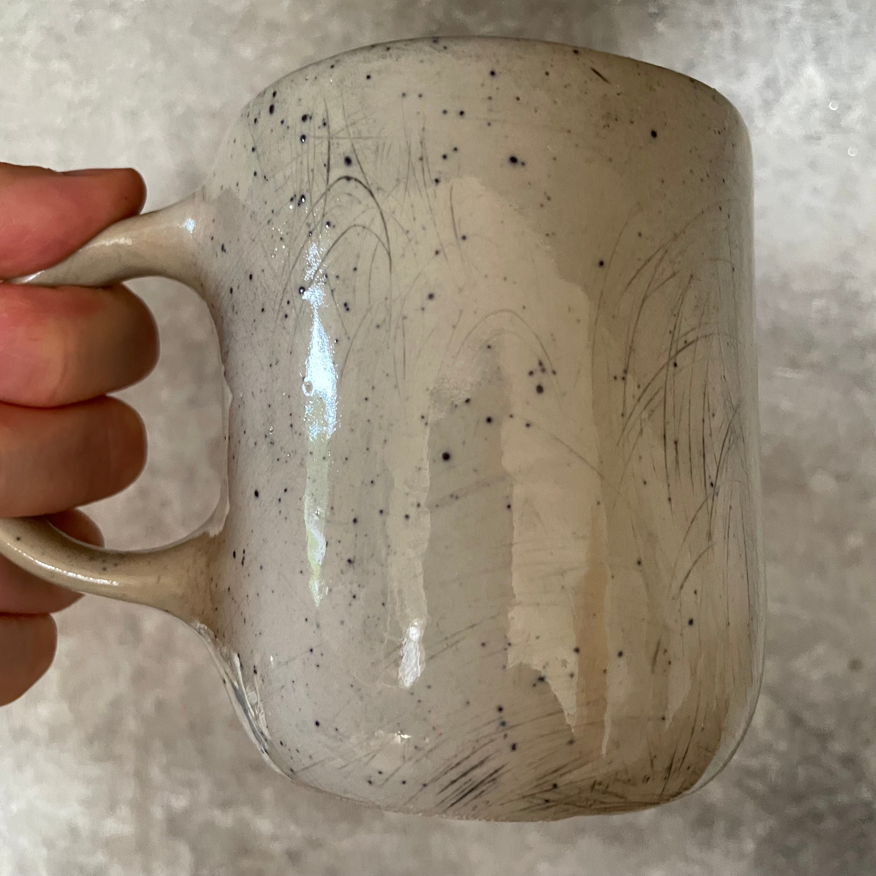 Speckled mug with words about work