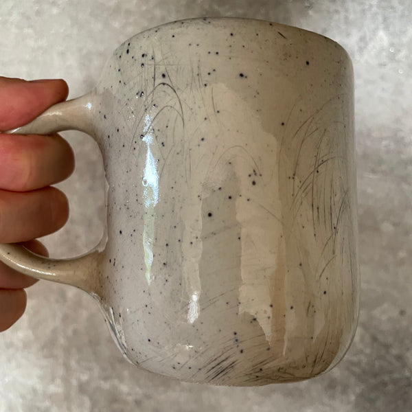 Speckled mug with words about work