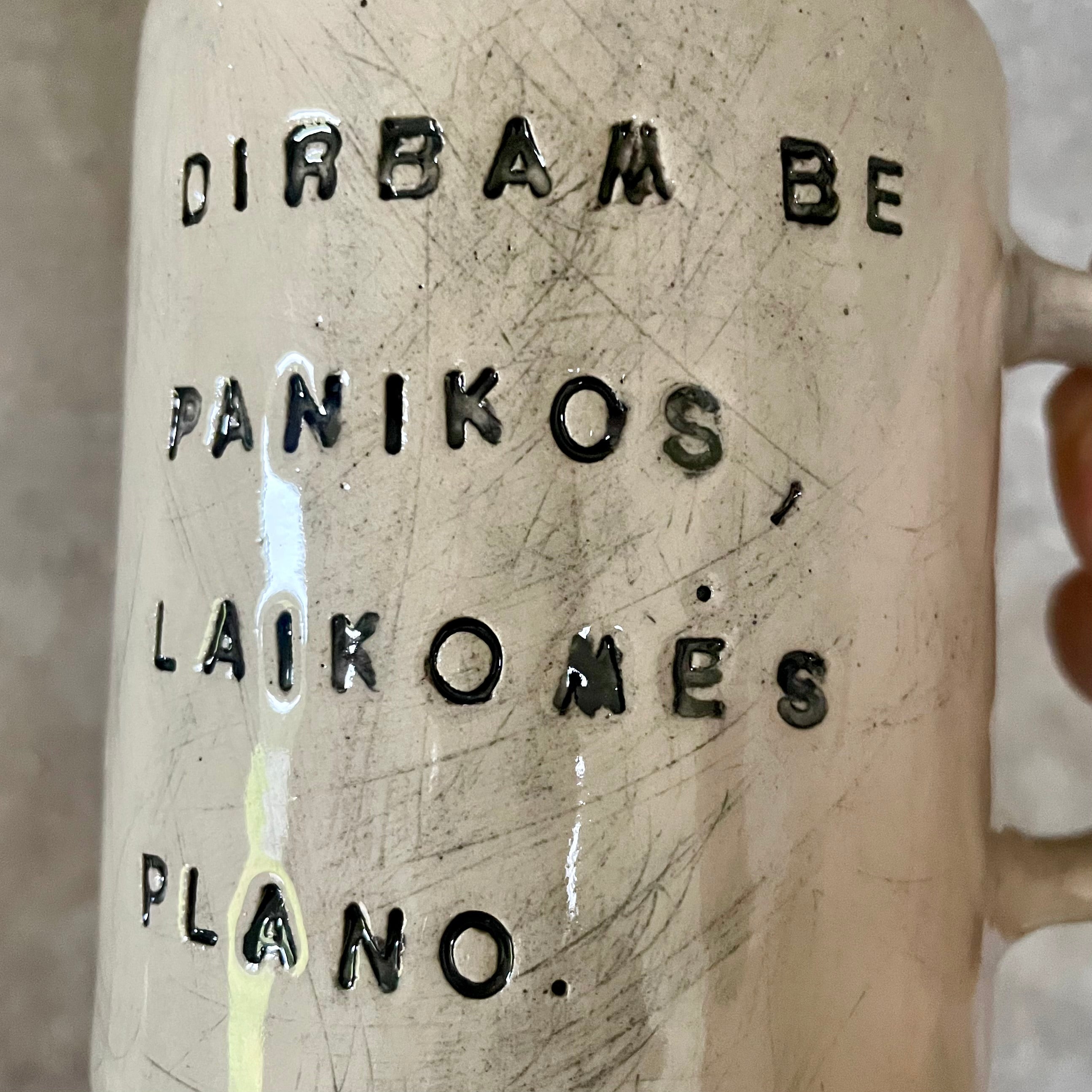White ceramic mug with words about work
