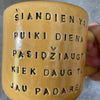 Yellow mug with optimistic text