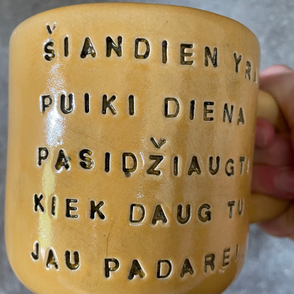 Yellow mug with optimistic text