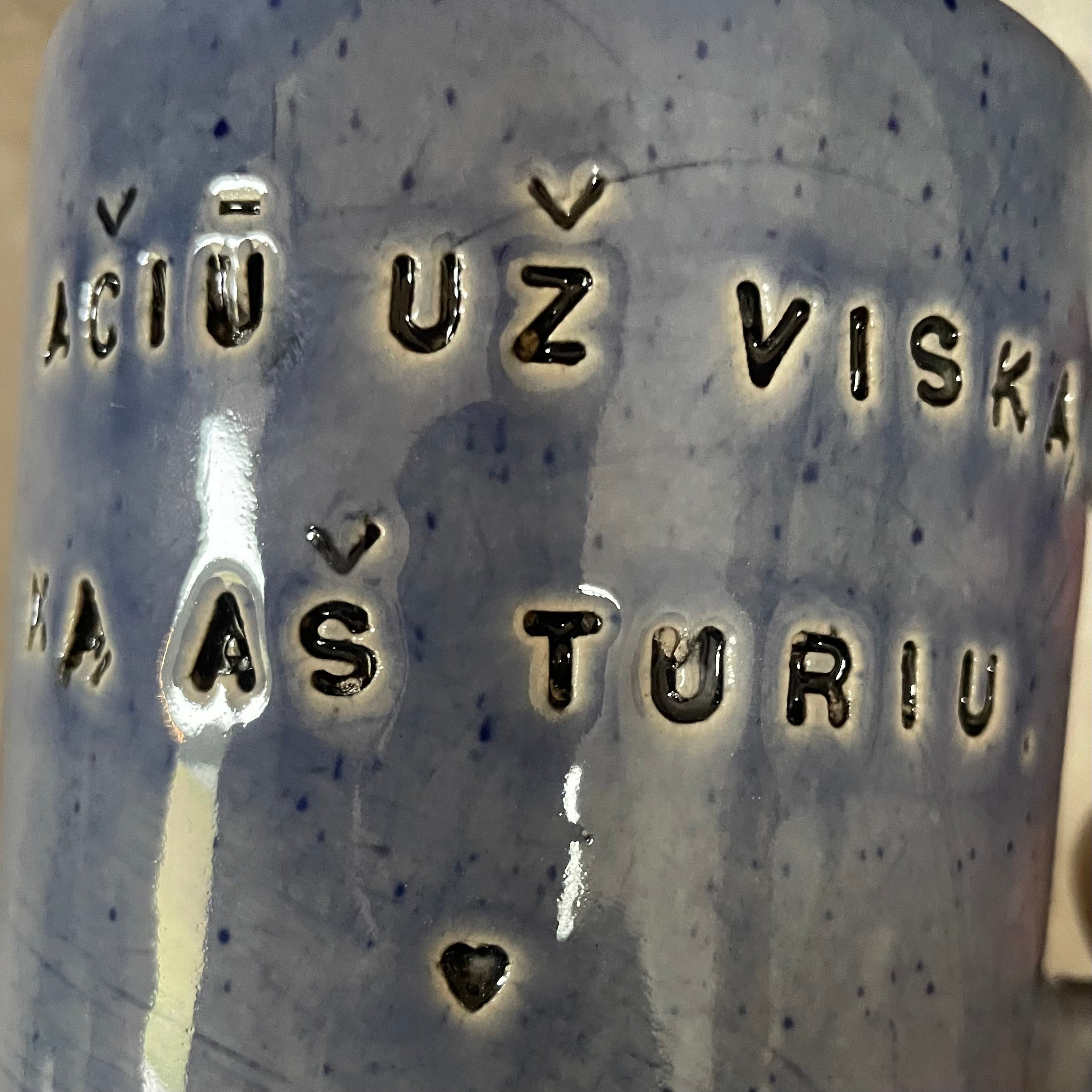Blue mug with words in Lithuanian