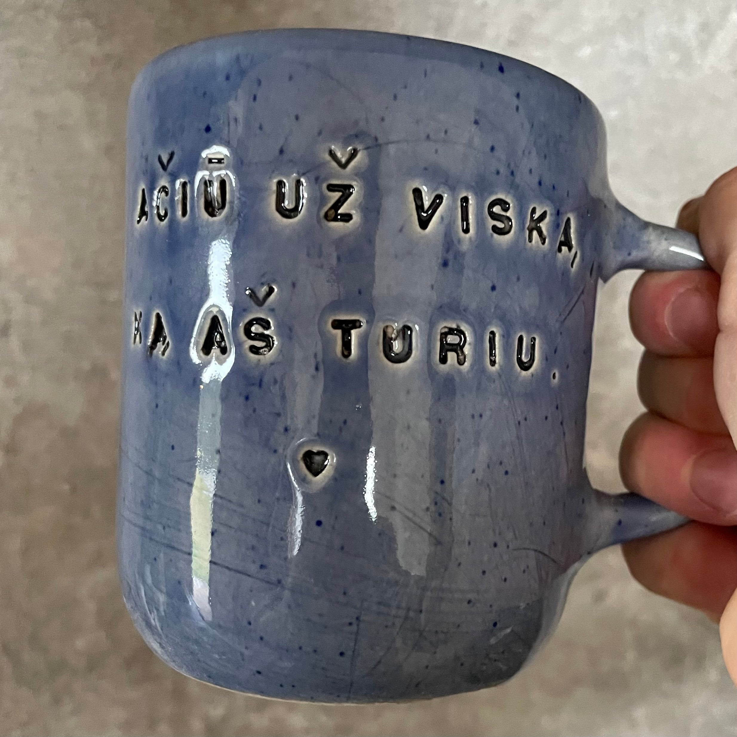 Blue mug with words in Lithuanian