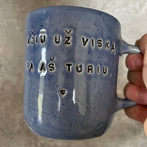 Blue mug with words in Lithuanian