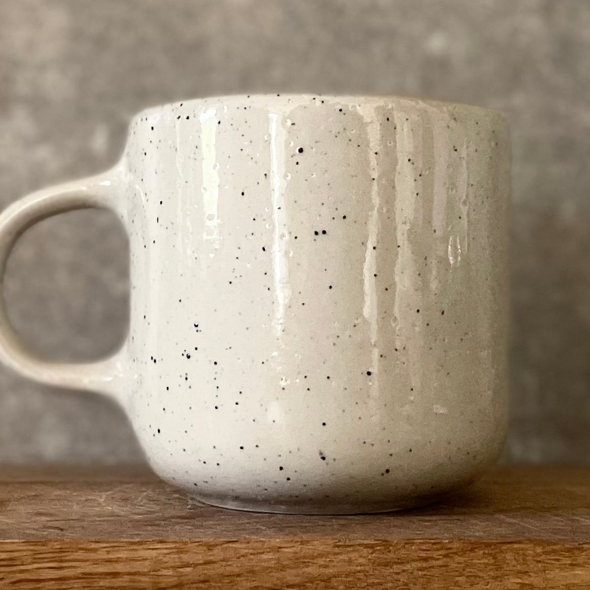 Speckled mug with cozy saying