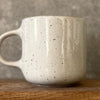 Speckled mug with cozy saying
