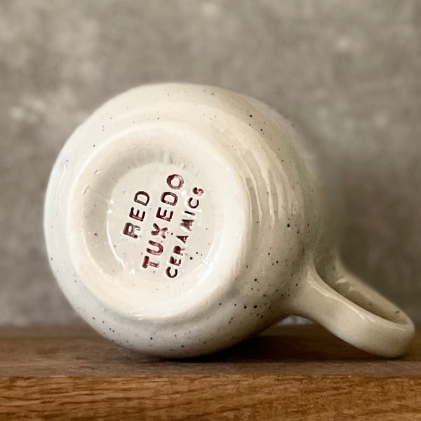 Speckled mug with cozy saying