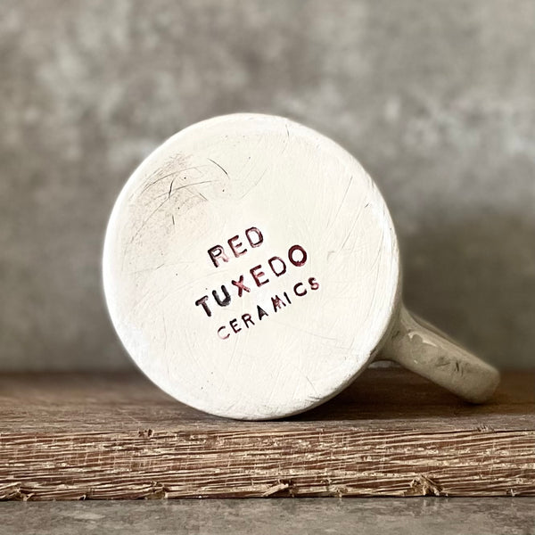 White ceramic mug with words about work