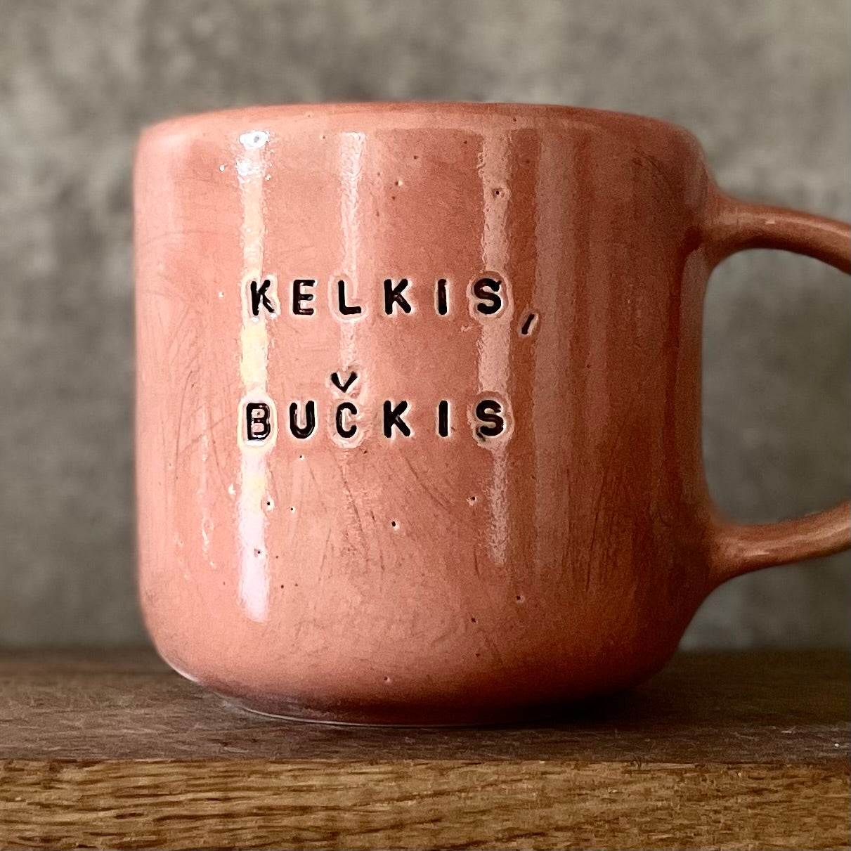 Big red mug with saying in Lithuanian