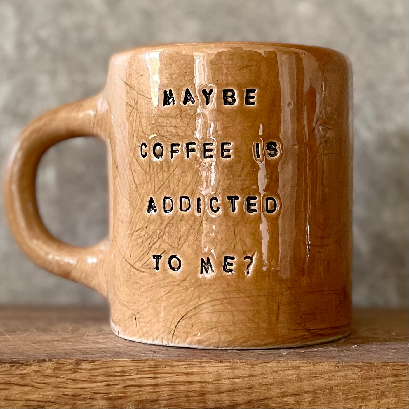 Brown mug with saying about coffee