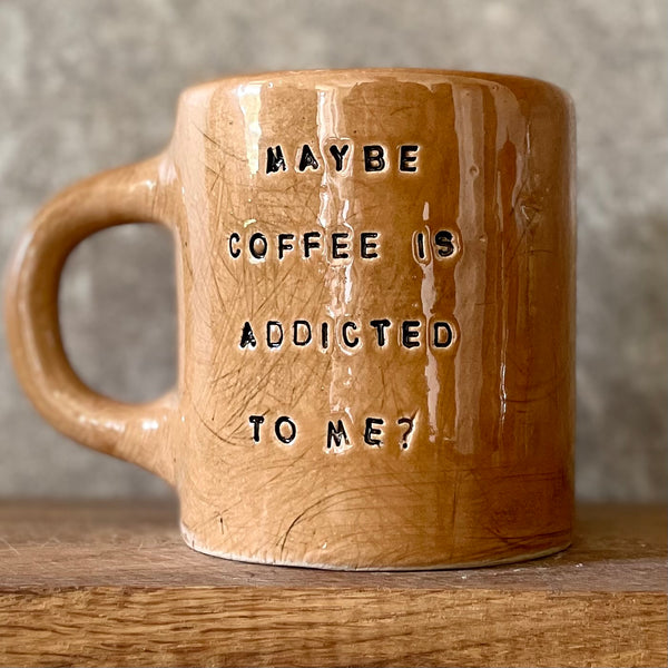 Brown mug with saying about coffee