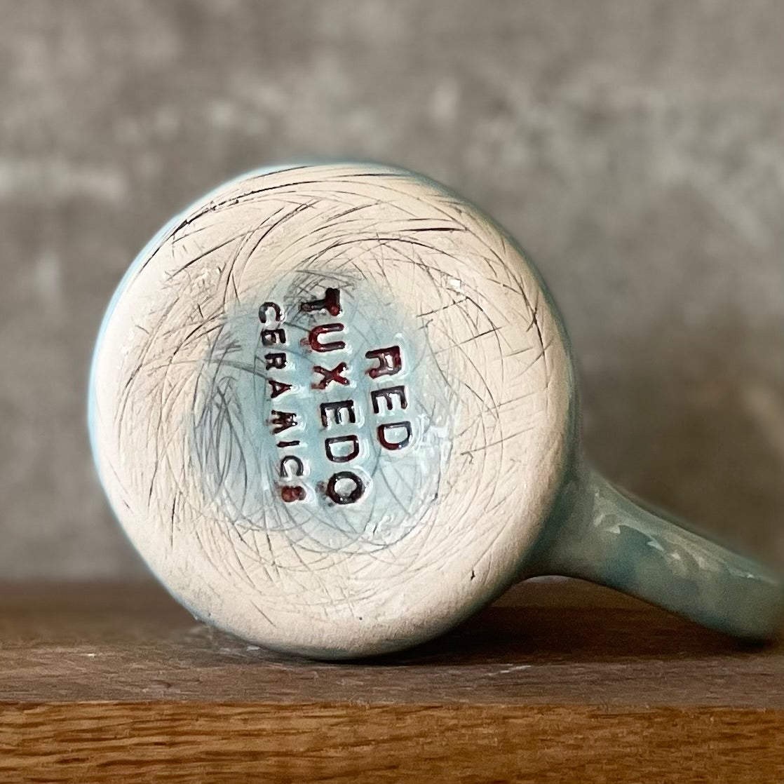 Blue ceramic mug with word PASITIKĖK