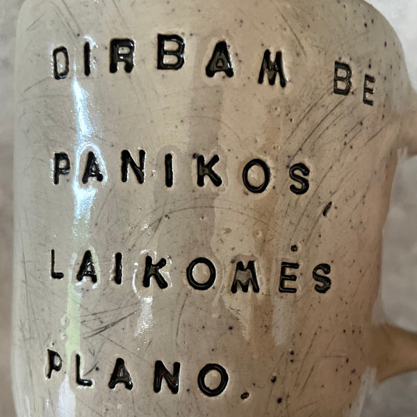 Speckled mug with words about work