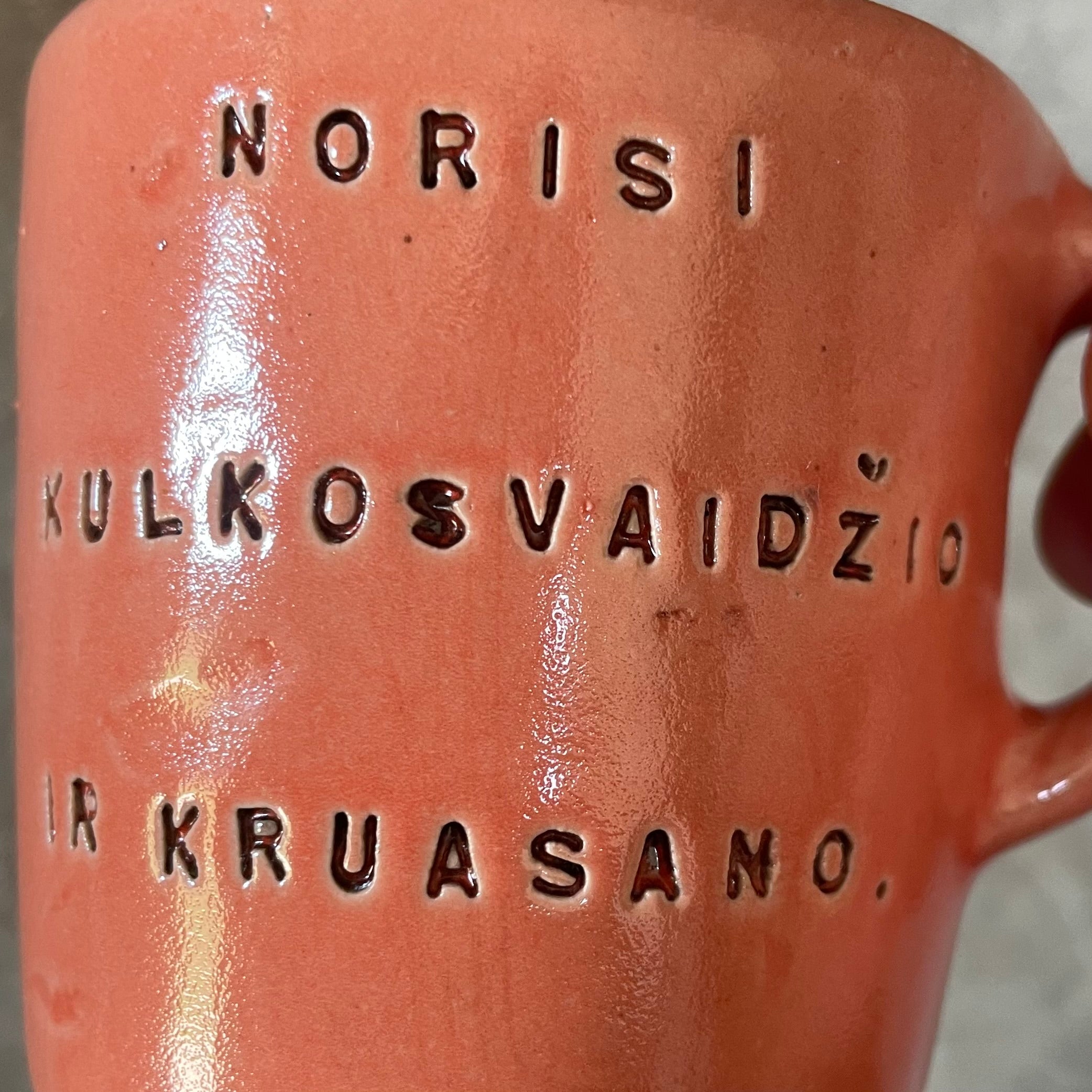 Small pink mug with funny phrase in Lithuanian