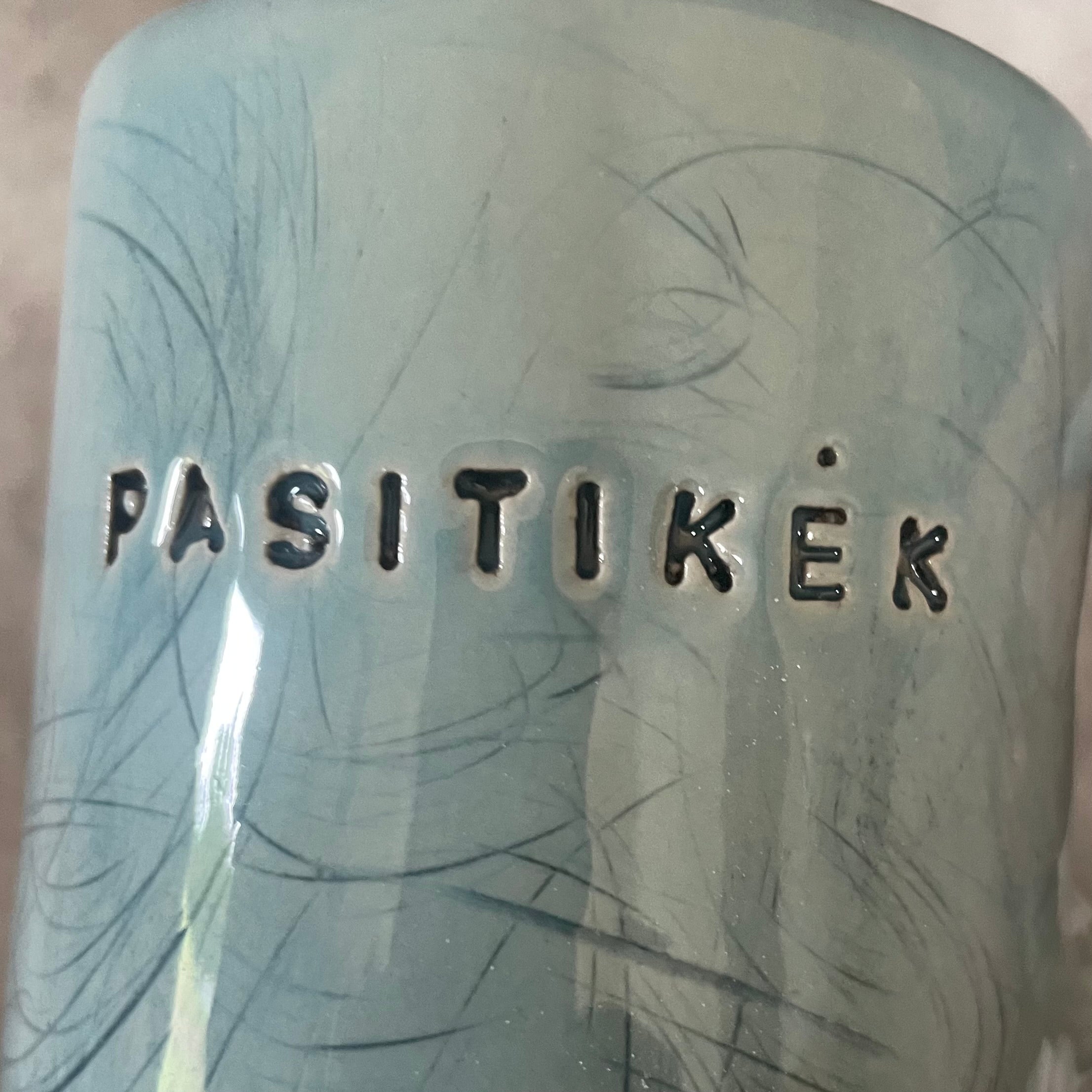 Blue ceramic mug with word PASITIKĖK