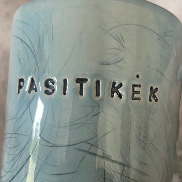 Blue ceramic mug with word PASITIKĖK
