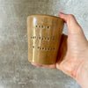 Caramel brown mug with phrase