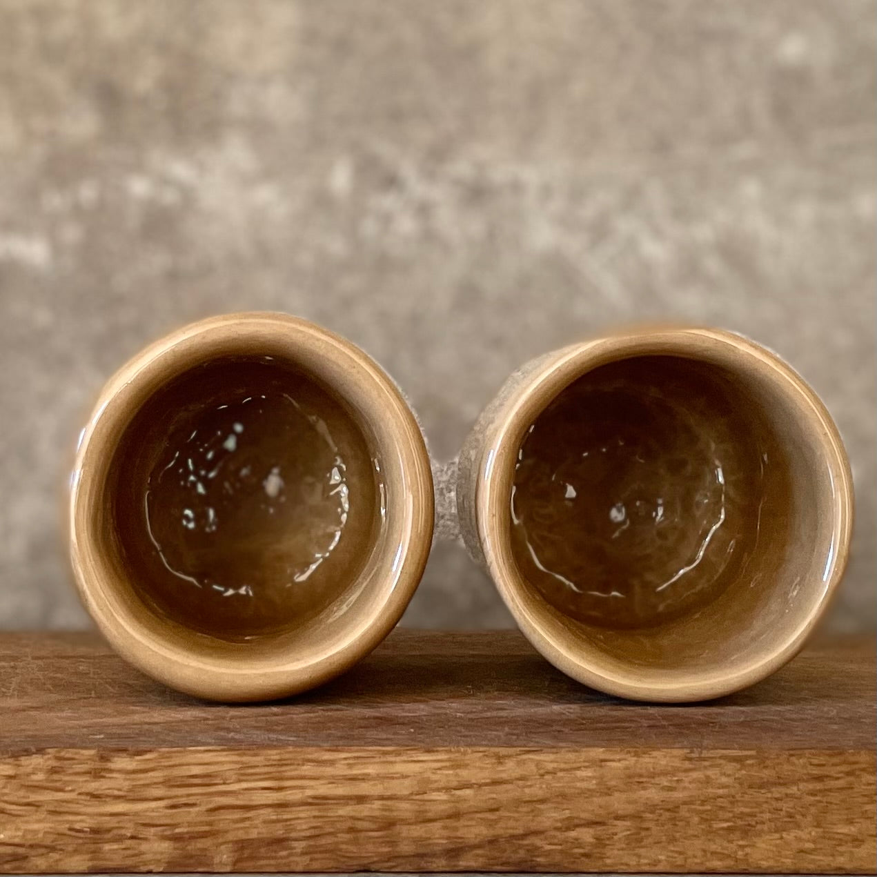 Brownish small mugs without handle with sentimental text
