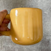 Yellow mug with optimistic text