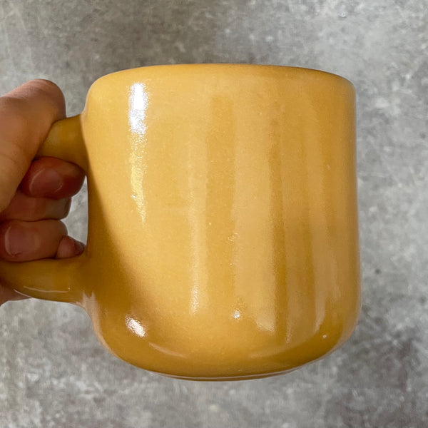 Yellow mug with optimistic text