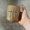 Beige tumbler mug with word RAMYBE