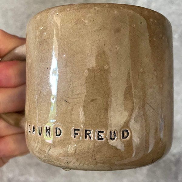 Brown mug with quote by S. Freud